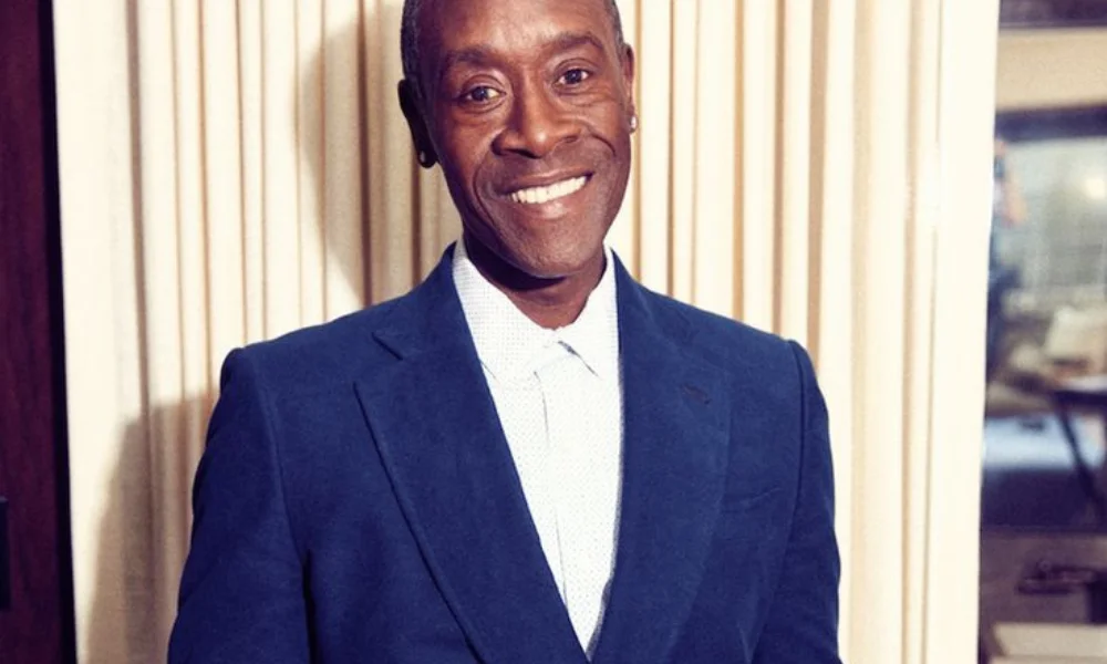 Man in a blue suit and white shirt smiles