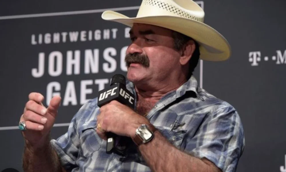 A man in a checkered shirt and cowboy hat-don frye net worth
