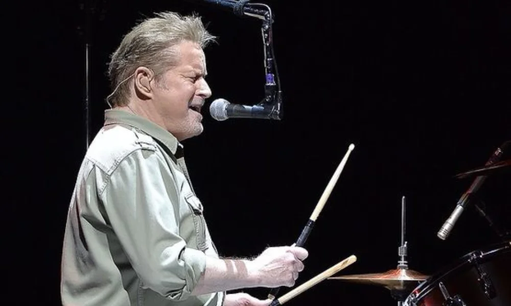 A man passionately sings into a microphone