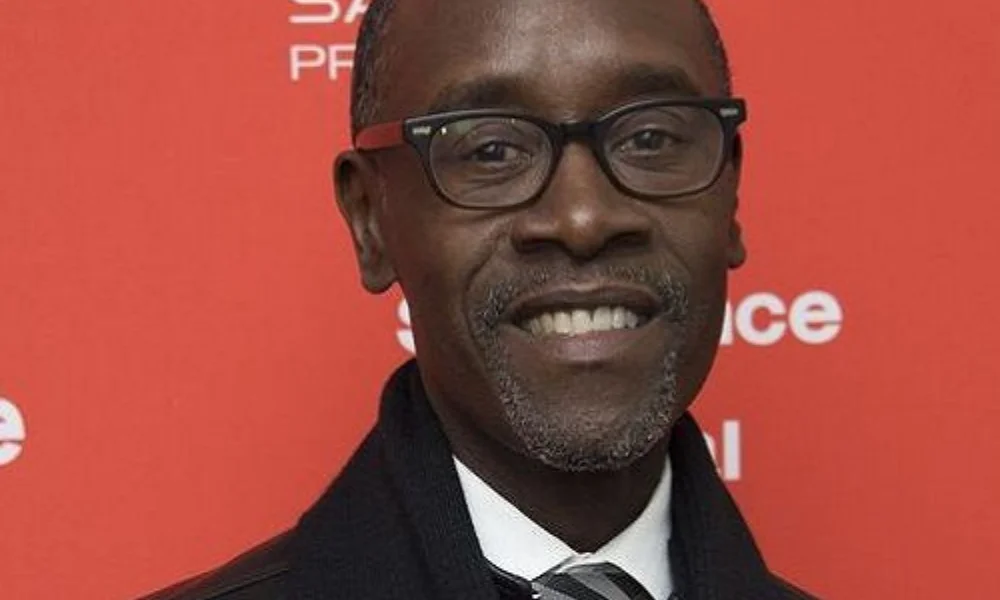 A man with glasses smiling