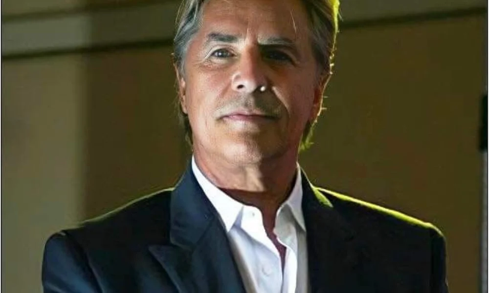 A man in a dark suit and white shirt-don johnson net worth