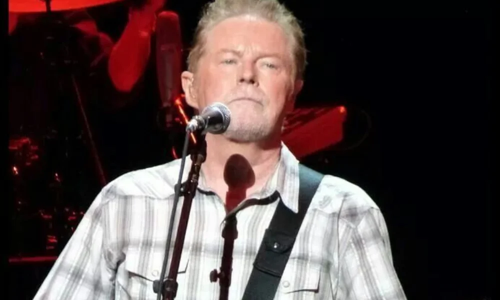 A man with a gray beard performs on stage-don henley net worth