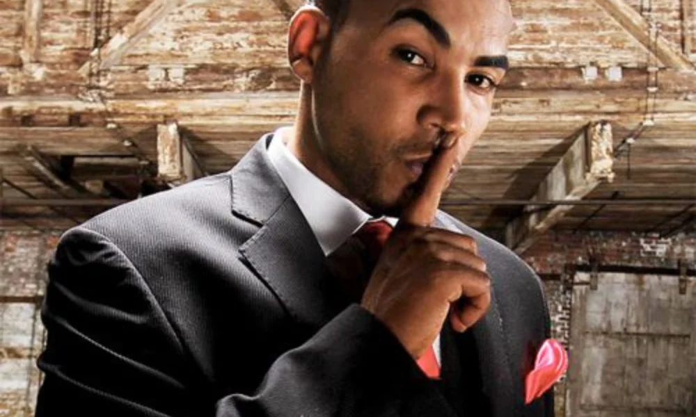A man in a suit-don omar net worth