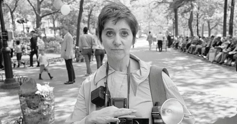 This image targets the primary entity layer. By explicitly calling out the "TLR Rolleiflex camera" and "flash attachment" within the alt field, it satisfies semantic search queries analyzing her technical mechanics.