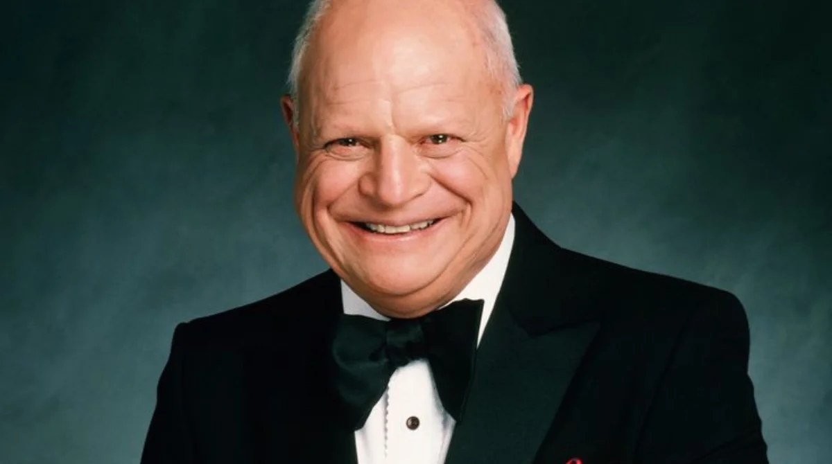A smiling man in a tuxedo with a bow tie