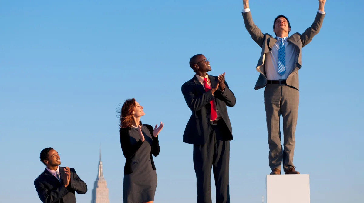 Four business professionals stand outdoors
