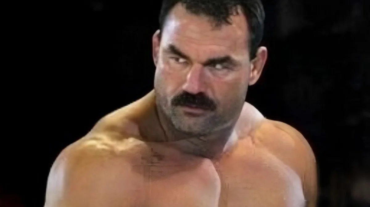 A muscular man with a thick mustache