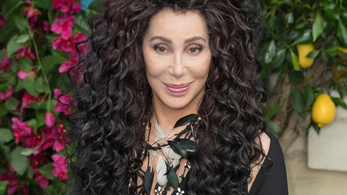 A person with long, curly black hair