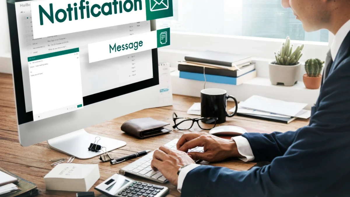 man in a suit types on a keyboard